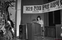 제2회 전태일 문학상 시상식에서 수상작을 읽는 여성 수상자 썸네일 이미지